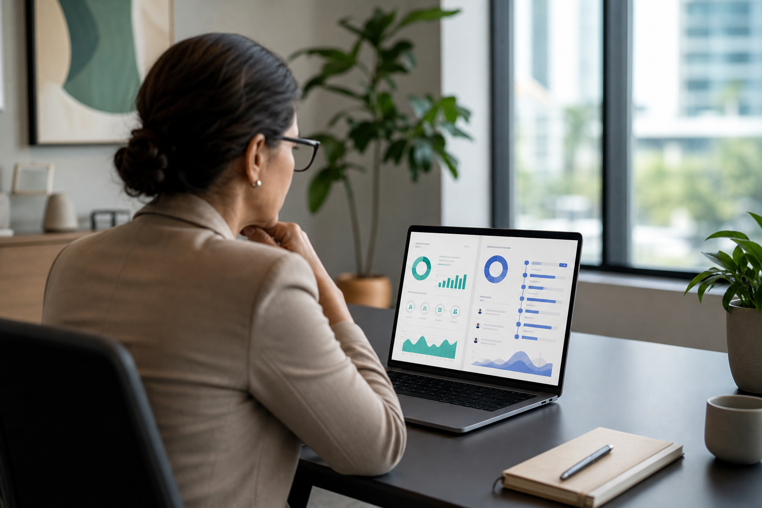HR manager reviewing payroll and performance dashboards